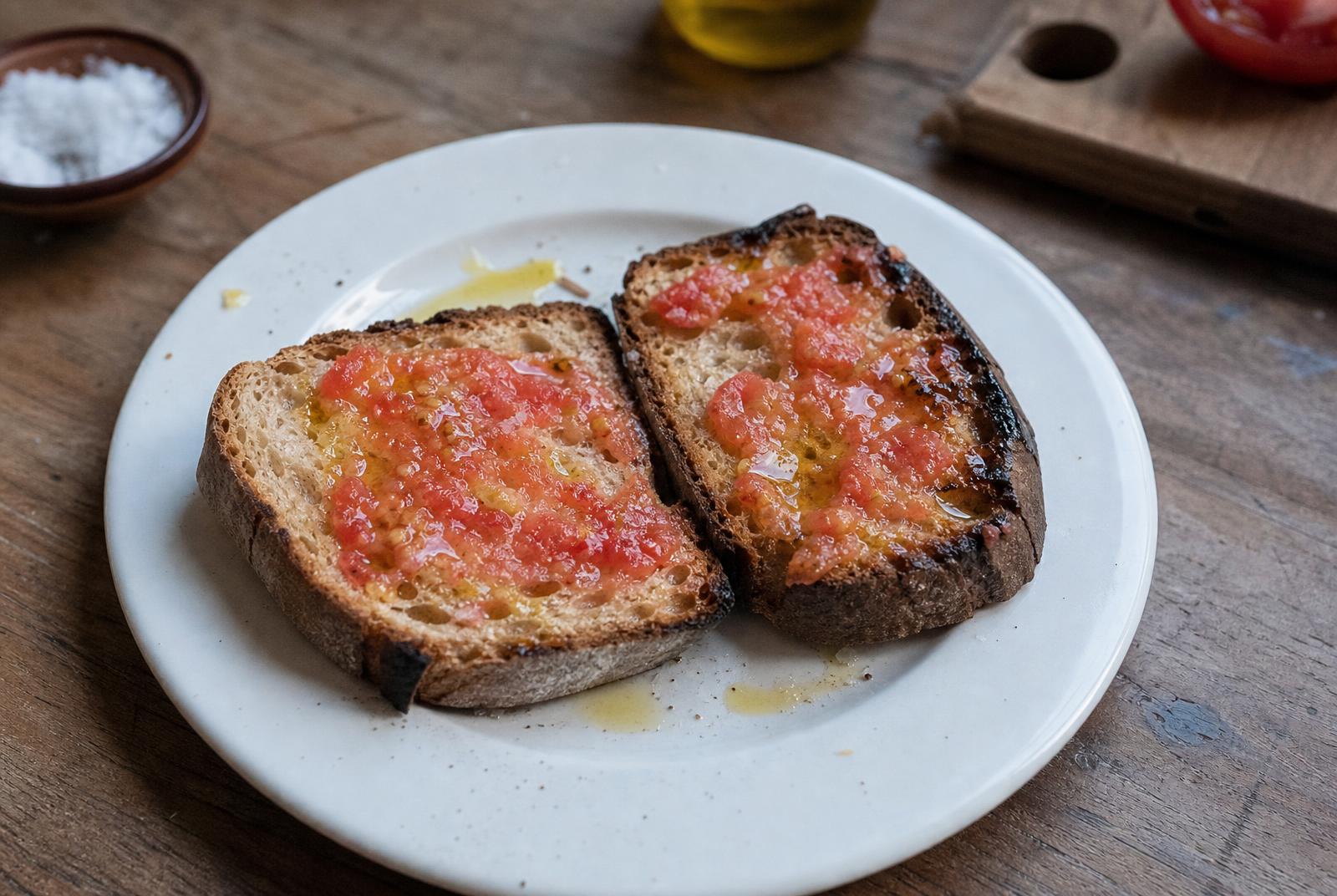 Charred sourdough rubbed with ripe tomato and poured with green olive oil