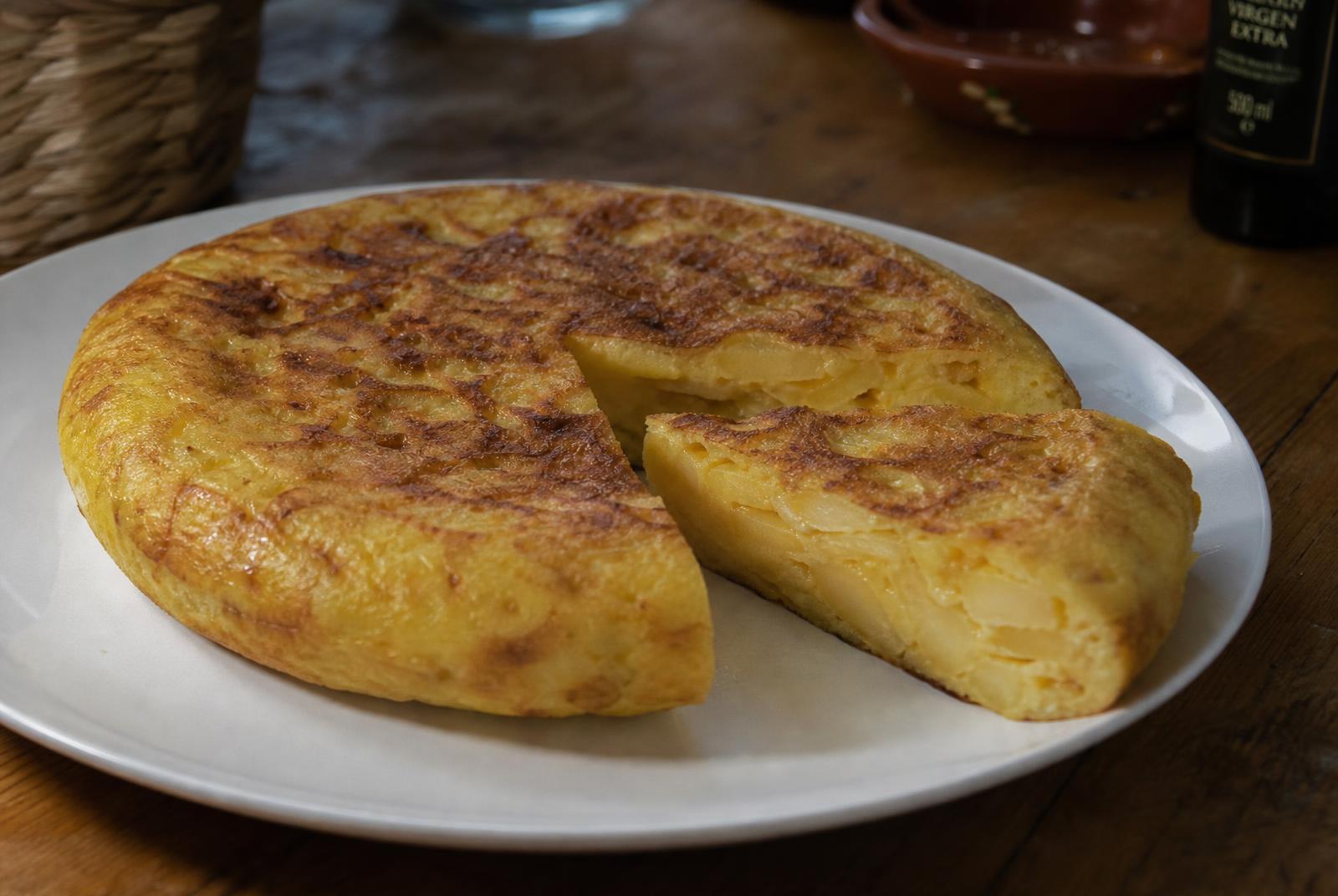 Spanish tortilla cut open to show tender layers of potato